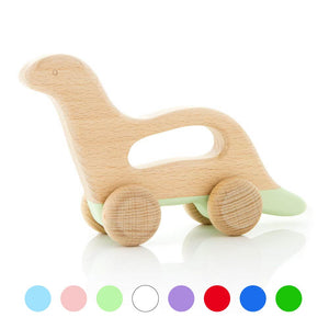 Wooden dinosaur toy in pastel green